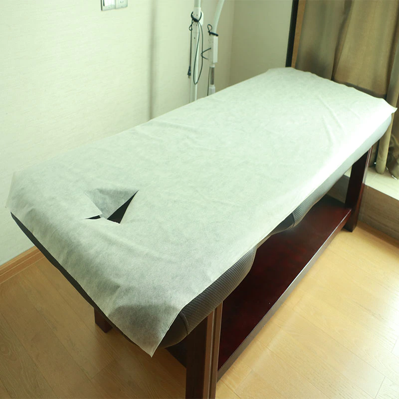 White non woven disposable massage table sheets roll with pre-cut face opening perforated 25gsm